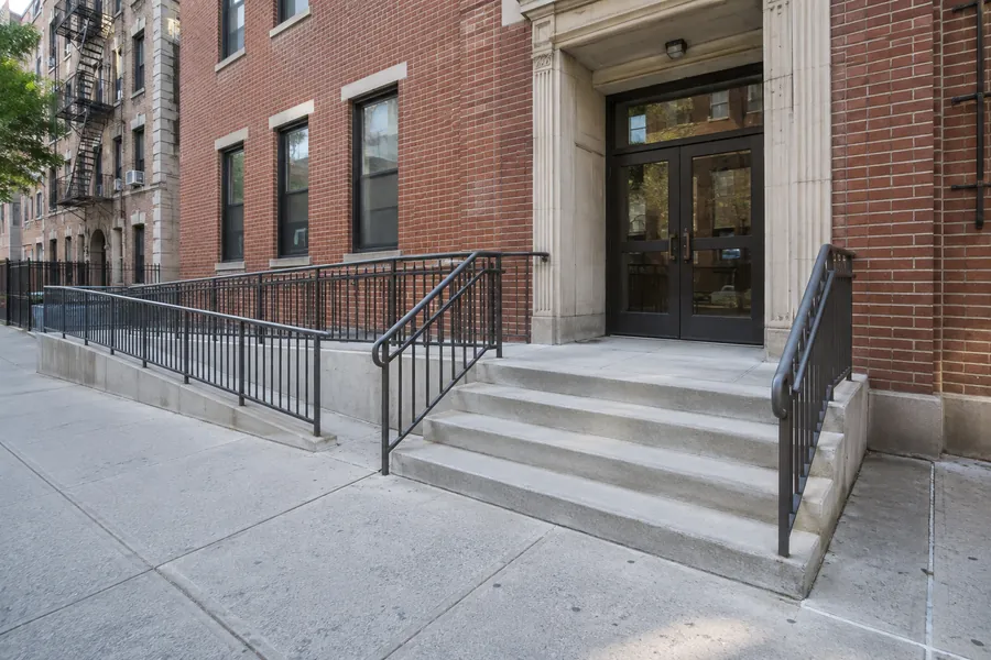 Repaired concrete stoop and entrance steps at an NYC residential property
