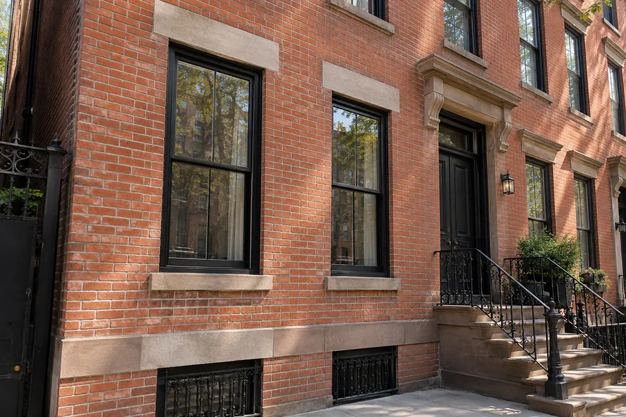 Brick facade repointing restoring aging mortar joints on an NYC building