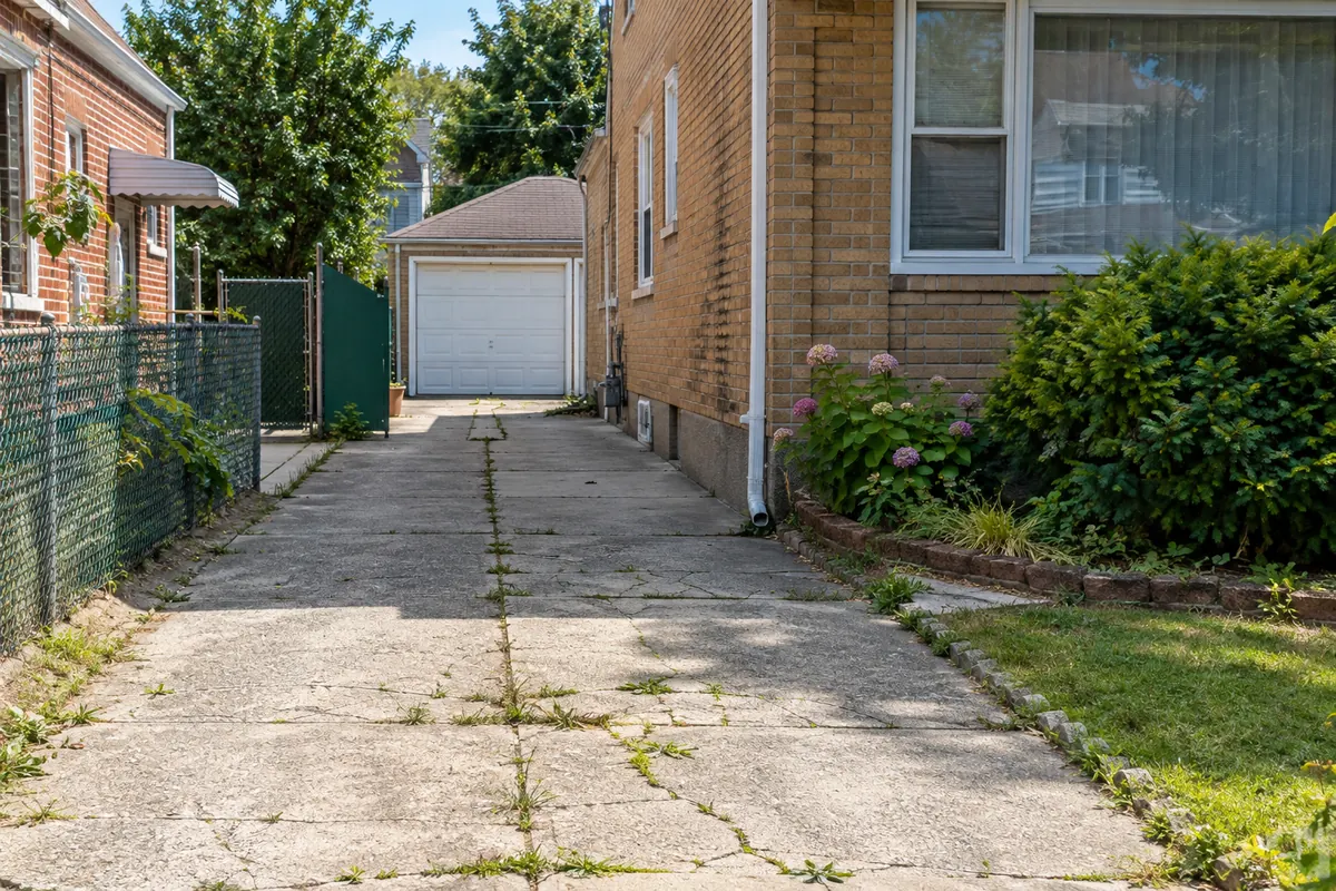 Worn and cracked concrete driveway before restoration and resurfacing